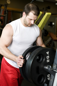 adding a plate to a barbell