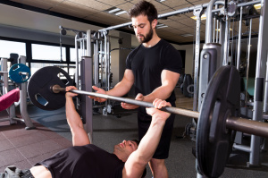 Bench press weightlifting man with personal trainer